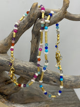 Load image into Gallery viewer, This bright and colorful gemstone and pearl necklace adds sunshine to any outfit.
Made from 18k yellow gold plated sterling silver and featuring various gemstones with a length of 38cm and extension chain of 5cm.
The pearls are 3.5mm and the gemstones are Carnelian, Amethyst, Amazonite, and Rose lisa.
It comes in Pink or Blue and has a matching bracelet that can be ordered separately