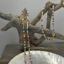 Load image into Gallery viewer, This bright and colorful gemstone and pearl necklace adds sunshine to any outfit.
Made from 18k yellow gold plated sterling silver and featuring various gemstones with a length of 38cm and extension chain of 5cm.
The pearls are 3.5mm and the gemstones are Carnelian, Amethyst, Amazonite, and Rose lisa.
It comes in Pink or Blue and has a matching bracelet that can be ordered separately