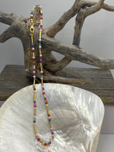 Load image into Gallery viewer, This bright and colorful gemstone and pearl necklace adds sunshine to any outfit.
Made from 18k yellow gold plated sterling silver and featuring various gemstones with a length of 38cm and extension chain of 5cm.
The pearls are 3.5mm and the gemstones are Carnelian, Amethyst, Amazonite, and Rose lisa.
It comes in Pink or Blue and has a matching bracelet that can be ordered separately