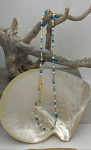 Load image into Gallery viewer, This bright and colorful gemstone and pearl necklace adds sunshine to any outfit.
Made from 18k yellow gold plated sterling silver and featuring various gemstones with a length of 38cm and extension chain of 5cm.
The pearls are 3.5mm and the gemstones are Carnelian, Amethyst, Amazonite, and Rose lisa.
It comes in Pink or Blue and has a matching bracelet that can be ordered separately