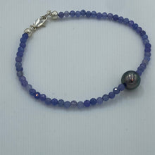 Load image into Gallery viewer, Tahitian pearl bracelet with faceted Tanzanite gemstones and a sterling silver peanut clasp. This stunning bracelet features a Tahitian pearl, round in shape, 9.2mm in size and beautiful 2mm Tanzanite beads. J3456