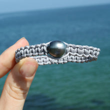 Load image into Gallery viewer, Thick Grey Macrame Bracelet featuring an Tahitian South Sea Pearl, Drop in shape, 11.8 x 13.1mm in size, Blue Green with Aubergine hues in colour. This bracelet is made from colour and water fast nylon material for heavy duty wear and tear, features no metal or glue. (J3318) Pictured on right in photo of three or third from left in group photo