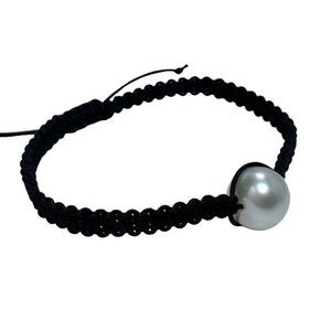 Thin Black Macrame bracelet featuring an Australian South Sea Pearl, Button shape, 11.3mm in size, White with Pink hues.  (J2876)  This bracelet is made from water and colorfast nylon material for heavy duty wear and tear, features no glue and no metal parts