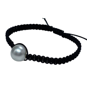 Thin Black Macrame bracelet featuring an Australian South Sea Pearl, Button shape, 11.3mm in size, White with Pink hues.  (J2876)  This bracelet is made from water and colorfast nylon material for heavy duty wear and tear, features no glue and no metal parts