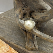 Load image into Gallery viewer, &#39;Anthea&#39; is an Australian South Sea Pearl ring with high shoulders and a sleek design for pearl protection and easy wear.

It features a Round 10.3mm pearl with white cream tones set on a 925 sterling silver ring that is rhodium coated for a non tarnish finish.

This pearl has Good lustre and light natural &#39;birthmarks&#39;

Size N1/2

J3550
