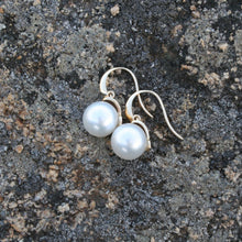 Load image into Gallery viewer, Australian South sea pearl earrings set on 9ct Yellow gold &#39;knife edge&#39; hooks, articulated to the cap that joins the pearls  The pearls are Gem grade, 11.2mm, Round AAA pearls that are White with Pink hues in color  J3213
