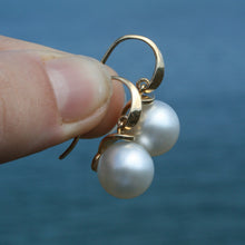 Load image into Gallery viewer, Australian South sea pearl earrings set on 9ct Yellow gold &#39;knife edge&#39; hooks, articulated to the cap that joins the pearls  The pearls are Gem grade, 11.2mm, Round AAA pearls that are White with Pink hues in color  J3213
