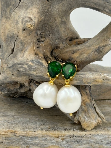 These fabulous stud style earrings are made of 18K gold plated 925 sterling silver. They feature beautiful claw set emerald green cubic zirconia with white button shape pearls.

The pearls measure 11-12mm.

The size from top to bottom is 25mm.