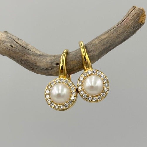 18K gold plated 925 Sterling silver hook earrings feature a white round pearl surrounded by cubic zirconia. 

Pearls measure 5-6mm.

Earrings measure 20mm.