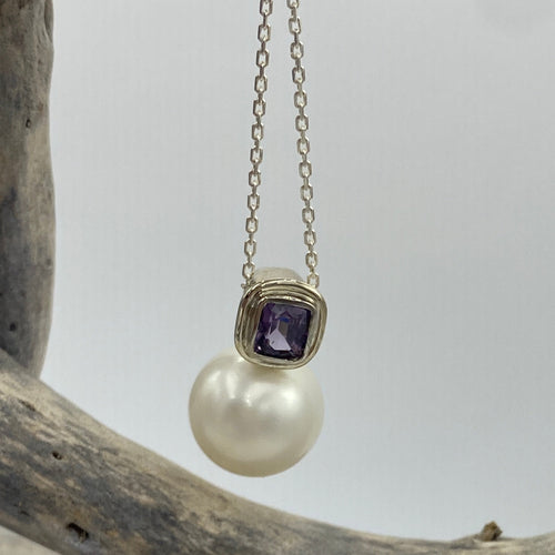 Australian south sea pearl pendant handcrafted 9ct white gold bezel set  with a natural purple Spinel stone, 1.48ct in size and cushion cut.  This pendant features a large Australian South Sea Broome origin pearl, 15mm in size, Round in shape, White in color with Good lustre and clean skin  J3399