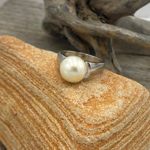 Load image into Gallery viewer, &#39;Anthea&#39; is an Australian South Sea Pearl ring with high shoulders and a sleek design for pearl protection and easy wear.

It features a Round 10.3mm pearl with white cream tones set on a 925 sterling silver ring that is rhodium coated for a non tarnish finish.

This pearl has Good lustre and light natural &#39;birthmarks&#39;

Size N1/2

J3550
