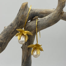 Load image into Gallery viewer, Satin finish 18k gold plated over 925 sterling silver hook style earrings  Featuring small White Drop shape pearls, 5 x 8mm in size, encapsulated in the orchid flower  Overall earring length of 30mm
