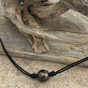  Double black leather necklet featuring a Dark Aubergine, Drop shape Tahitian South Sea Pearl 11.5mm in size. The color of this pearl is stunning and bright.

This pearl has High lustre and natural 'birthmarks'.&nbsp;

The necklace is leather and has a silver Cartier clasp and is a rich Pindan in color.

The length is adjustable from 45 to 51cm using the extension chain

J3256