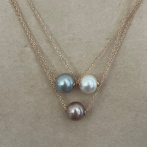This Slider necklace features a single 10-11mm Round freshwater pearl   Choose a Pink, White or Grey pearl  Then choose if you want a rose gold or silver chain  The chain is Sterling Silver Trace Chain with a protective cheneer tube through the pearl for protection and easy sliding  The chains are adjustable in length from 40cm or 45cm