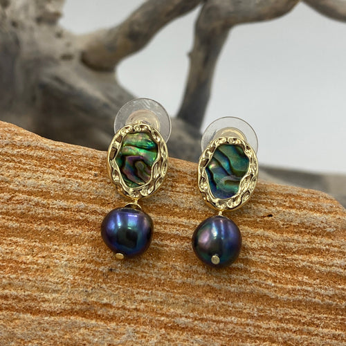 Hand crafted, stud style, gold plated over Sterling silver earrings that feature ornate bezel set blue green paua and 8mm round freshwater pearls that are black with blue hues.

Size in total is 24mm from top to bottom