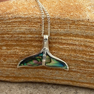 Sterling Silver Pendant features green blue NZ Paua&nbsp; shell in the shape of a Whale Tail.

It is 25mm across the tail flukes

Price includes Base Metal chain.