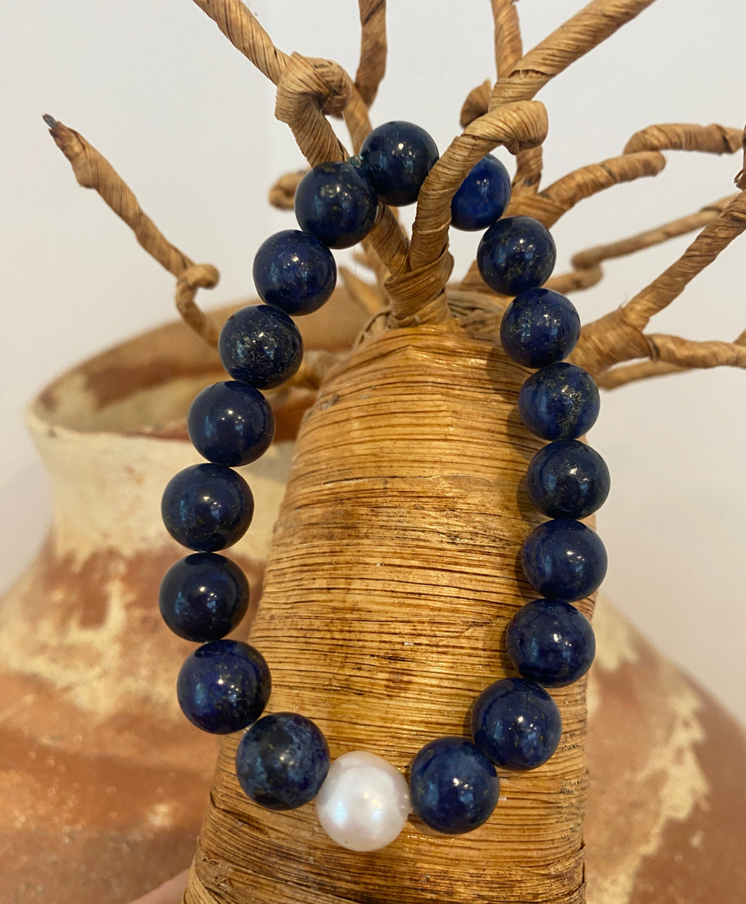 Polished 10.5mm Lapis Bead bracelet featuring an 11mm White Round freshwater pearl

These beads are on heavy duty elastic and fit 19-20cm wrist