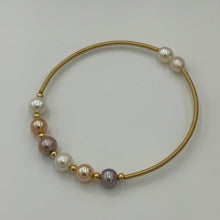 Load image into Gallery viewer, 14ct Gold plated Sterling silver wire wrap bracelet featuring a mix of 6 natural white, pink and lavender hue freshwater pearls, round shaped, 7mm in size and 2 smaller white pearls 5.9mm on ends.
