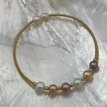 Load image into Gallery viewer, 14ct Gold plated Sterling silver wire wrap bracelet featuring a mix of 6 natural white, pink and lavender hue freshwater pearls, round shaped, 7mm in size and 2 smaller white pearls 5.9mm on ends.
