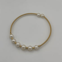 Load image into Gallery viewer, 14ct Gold plated Sterling silver wire wrap bracelet featuring 6 natural white freshwater pearls, round shaped, 7mm in size with 2 smaller white 5.8mm pearls on the ends.
