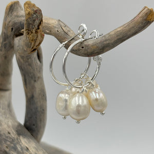 These fashion jewellery earrings feature an elegant hoop design adorned with multiple lustrous freshwater pearl drops, creating a graceful and eye-catching effect.&nbsp;

Pearls measure approx. 8mm and 6mm.

Total length from top to bottom is 35mm.