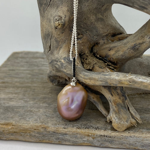 'Kittie' is a stunning large  Baroque Freshwater Edison Pearl set in a 925 Sterling silver pendant set with Black cubic Zirconia

This large pearl is 15.5 mm wide and  20mm high with  beautiful lustre and a deep natural lavender and pink and apricot hues