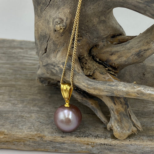 'Kate' is a stunning large Round Freshwater Edison Pearl set on a 9ct yellow gold pendant

This large Round pearl is 13.8 mm in size with high lustre and the most stunning natural lavender color 