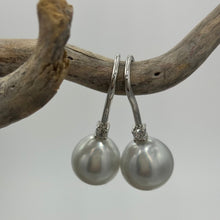 Load image into Gallery viewer, Classic style hook earrings featuring Australian South Sea Pearls on 925 sterling silver set with claw set Cubic Zirconia  They feature Semi Baroque Drop shaped pearls,&nbsp; 11mm x 12mm in size and White with Pink Silver hues in colour.  High lustre  J3461
