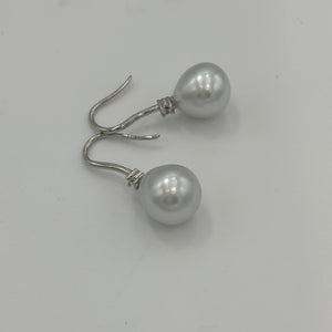 Australian South Sea Pearl earrings on 925 sterling silver shepherd hooks set with Cubic Zirconia  They feature Semi Baroque shaped pearls,&nbsp; 11mm x 12mm in size and White with silver and pink hues in colour.  High lustre  J3461