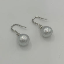 Load image into Gallery viewer, Australian South Sea Pearl earrings on 925 sterling silver shepherd hooks set with Cubic Zirconia  They feature Semi Baroque shaped pearls,&nbsp; 11mm x 12mm in size and White with silver and pink hues in colour.  High lustre  J3461
