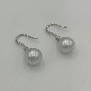 Australian South Sea Pearl earrings on 925 sterling silver shepherd hooks set with Cubic Zirconia  They feature Semi Baroque shaped pearls,&nbsp; 11mm x 12mm in size and White with silver and pink hues in colour.  High lustre  J3461