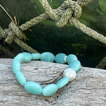 Load image into Gallery viewer, &lt;p&gt;Stunning Amazonite bracelet featuring a white Australian South Sea Pearl&lt;/p&gt; &lt;p&gt;Pearl is circle drop in shape, and is 11.2 x 12.5mm in size and white in colour&lt;/p&gt; &lt;p&gt;The Amazonite beads are flat oval facetted and are 10 x 16mm in size&lt;/p&gt; &lt;p&gt;This bracelet is easy to slip on and off as it&#39;s made on elastic&lt;/p&gt; &lt;p&gt;J3360&lt;/p&gt;
