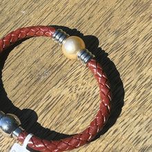 Load image into Gallery viewer, &lt;p&gt;&#39;Lydia&#39; is a braided leather bracelet featuring a Golden South Sea Pearl&lt;/p&gt; &lt;p&gt;Pearl is a near round in shape, 12.4mm in size and is golden in colour&lt;/p&gt; &lt;p&gt;This bracelet is made out of braided brown leather and stainless steel with a magnetic clasp&lt;/p&gt; &lt;p&gt;J3349&lt;/p&gt;
