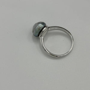 This ring features a Tahitian South Sea Pearl set in&nbsp;925 sterling silver and rhodium coated for a non tarnish finish. This Blue pearl is an unusual Baroque Button shape and 10.7mm x 11.2mm in size.    Size P/ 57  J3438