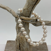 Load image into Gallery viewer, Stunning Akoya pearl strand bracelet, high lustre, and white with pink hues in color  This bracelet features twenty three round pearls, 7mm- 7.5mm,&nbsp; with a 9ct white gold traditional ball clasp.  It is 19cm including the clasp  J3396
