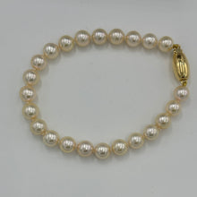 Load image into Gallery viewer, Timeless and Classic bracelet featuring stunning Acoya Sea pearls.  This bracelet features twenty three round pearls, 7mm- 7.5mm,&nbsp; with an 18ct yellow gold magnetic clasp.
