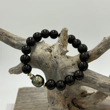 Load image into Gallery viewer, A stunning stretch bracelet featuring a beautiful Peacock Fijian South Sea Pearl highlighted by the Ebony beads.  The Pearl is Circle Drop in shape, is 11.3mm x 14mm in size and features shades of peacock blue and green.  J3474
