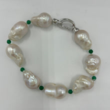 Load image into Gallery viewer, This stunning baroque Freshwater pearl bracelet features Eight High lustre pearls, 13 x 21mm in size and&nbsp; white in colour.  These pearls are highlighted between each pearl with a facetted 4mm Green&nbsp; Onyx gemstones.  It has a rhodium coated non tarnish 925 Sterling Silver clasp.  The length including clasp is 22cm.
