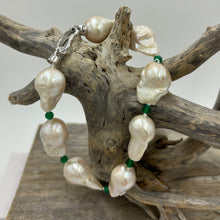 Load image into Gallery viewer, This stunning baroque Freshwater pearl bracelet features Eight High lustre pearls, 13 x 21mm in size and&nbsp; white in colour.  These pearls are highlighted between each pearl with a facetted 4mm Green&nbsp; Onyx gemstones.  It has a rhodium coated non tarnish 925 Sterling Silver clasp.  The length including clasp is 22cm.
