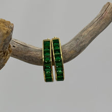 Load image into Gallery viewer, Elegant 18ct Gold-plated huggie style hoops featuring baguette-cut green cubic zirconia stones. These stunning earrings add color to any outfit&nbsp;

Size 15mm from top to bottom and 3.8mm wide

Also available in Blue
