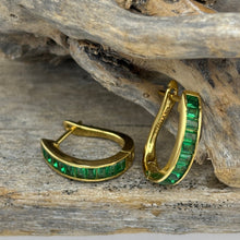 Load image into Gallery viewer, Elegant 18ct Gold-plated huggie style hoops featuring baguette-cut green cubic zirconia stones. These stunning earrings add color to any outfit&nbsp;

Size 15mm from top to bottom and 3.8mm wide

Also available in Blue
