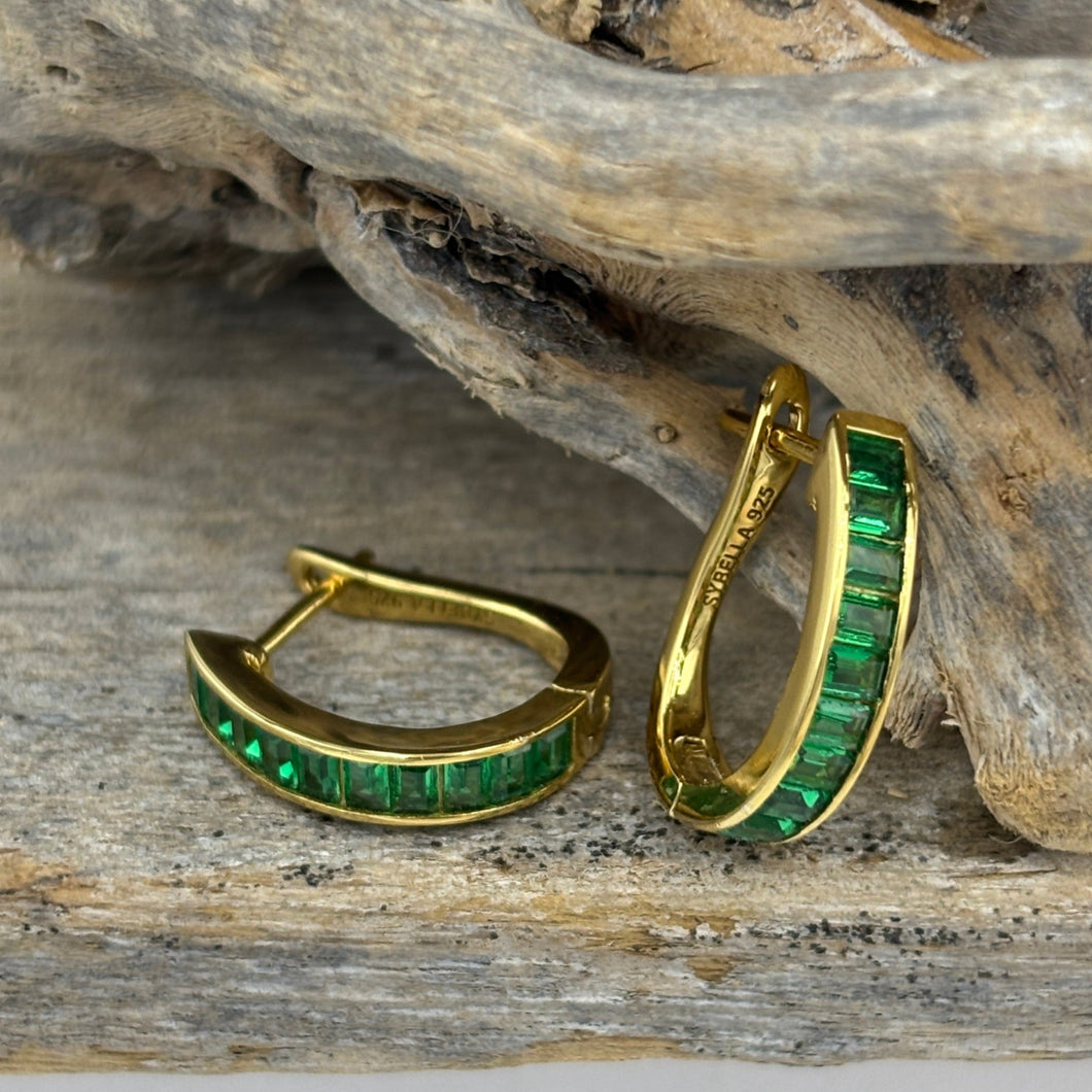 Elegant 18ct Gold-plated huggie style hoops featuring baguette-cut green cubic zirconia stones. These stunning earrings add color to any outfit 

Size 15mm from top to bottom and 3.8mm wide

Also available in Blue