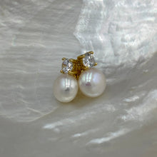 Load image into Gallery viewer, These fabulous stud style earrings are made of 18K gold plated 925 sterling silver. They feature a claw set cubic zirconia with a button shape white freshwater pearl.

The pearls measure 10mm.
