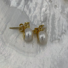 Load image into Gallery viewer, These fabulous stud style earrings are made of 18K gold plated 925 sterling silver. They feature a claw set cubic zirconia with a button shape white freshwater pearl.

The pearls measure 10mm.
