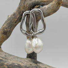 Load image into Gallery viewer, The &#39;Linked Gem&#39; 925 Sterling Silver Earrings feature lustrous Freshwater Pearls on abstract silver hoops.

Stud fitting with overall measurement: 37 x 14mm
Pearl size: 10-12mm
