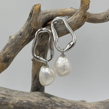 Load image into Gallery viewer, The &#39;Linked Gem&#39; 925 Sterling Silver Earrings feature lustrous Freshwater Pearls on abstract silver hoops.

Stud fitting with overall measurement: 37 x 14mm
Pearl size: 10-12mm
