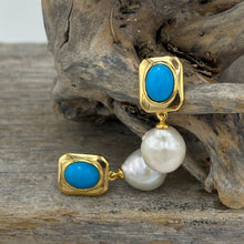 Load image into Gallery viewer, The &#39;Blue Light&#39; Drop Studs are crafted from 18K gold-plated 925 sterling silver, featuring a striking combination of freshwater pearls and vibrant turquoise accents.

Pearls measure 11mm.

Total length 26mm.
