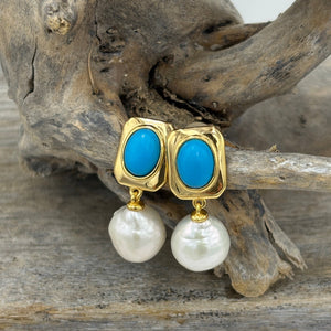 The 'Blue Light' Drop Studs are crafted from 18K gold-plated 925 sterling silver, featuring a striking combination of freshwater pearls and vibrant turquoise accents.

Pearls measure 11mm.

Total length 26mm.