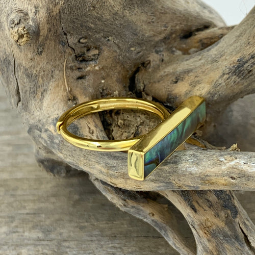 18K gold plated sterling silver with bezel set New Zealand Blue Green Paua shell inlay.  The finish is polished and this ring is adjustable in size.