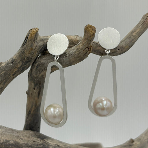 Sterling silver stud style earrings.  Satin finish long drop earrings featuring a Silver `12mm disc as the Stud with Long Silver teardrops to house the beautiful 11mm Round Freshwater pearls, White with Pink hues.  Length overal from top to bottom is 52mm.